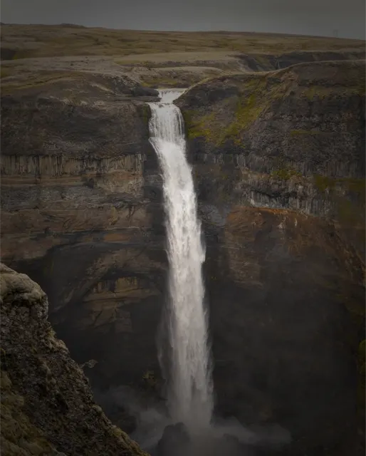 Waterfall plunging into a canyon