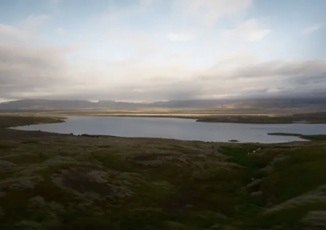 Lake beneath distant mountains
